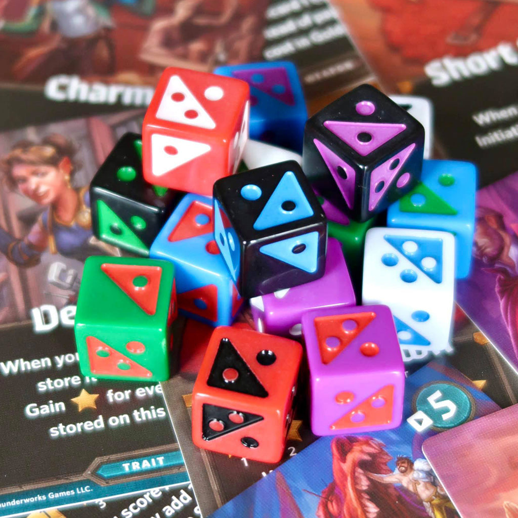 Pile of split dice, which feature two colors on each side, for Roll Player: Fiends & Familiars