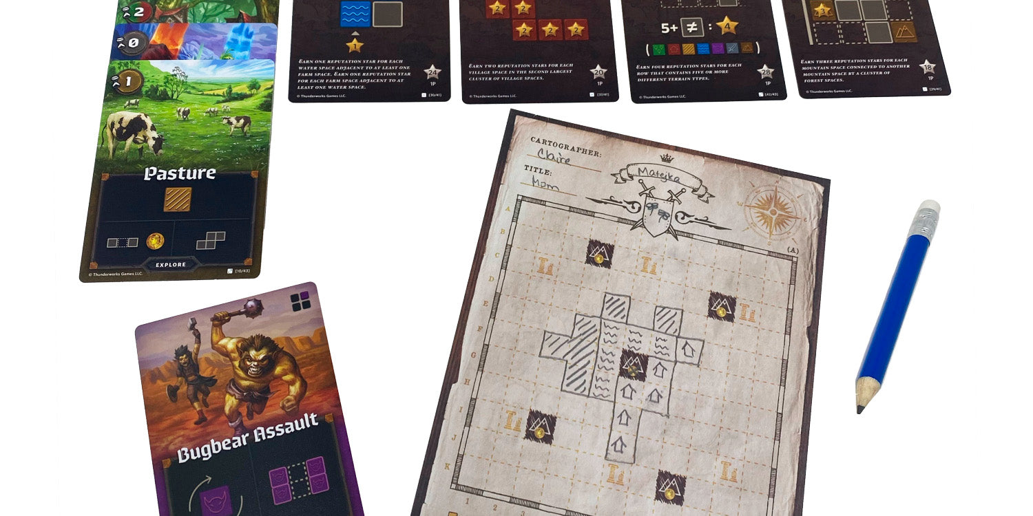 In-play image of Cartographers. Shows a map sheet, and various explore cards.
