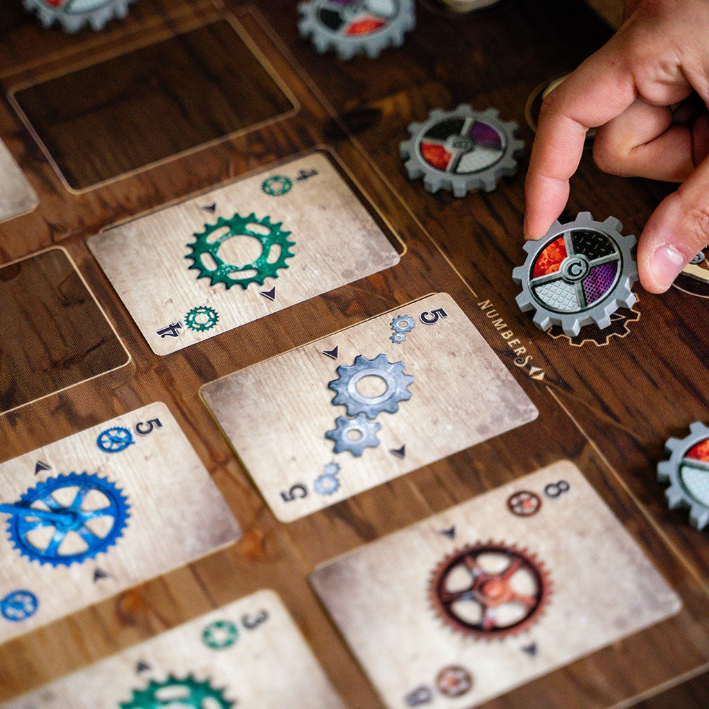 Person turning gear token after playing card in Gearworks